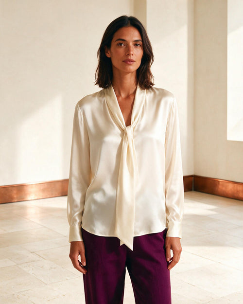 Modelo usando blusa acetinada marfim com gola fluida